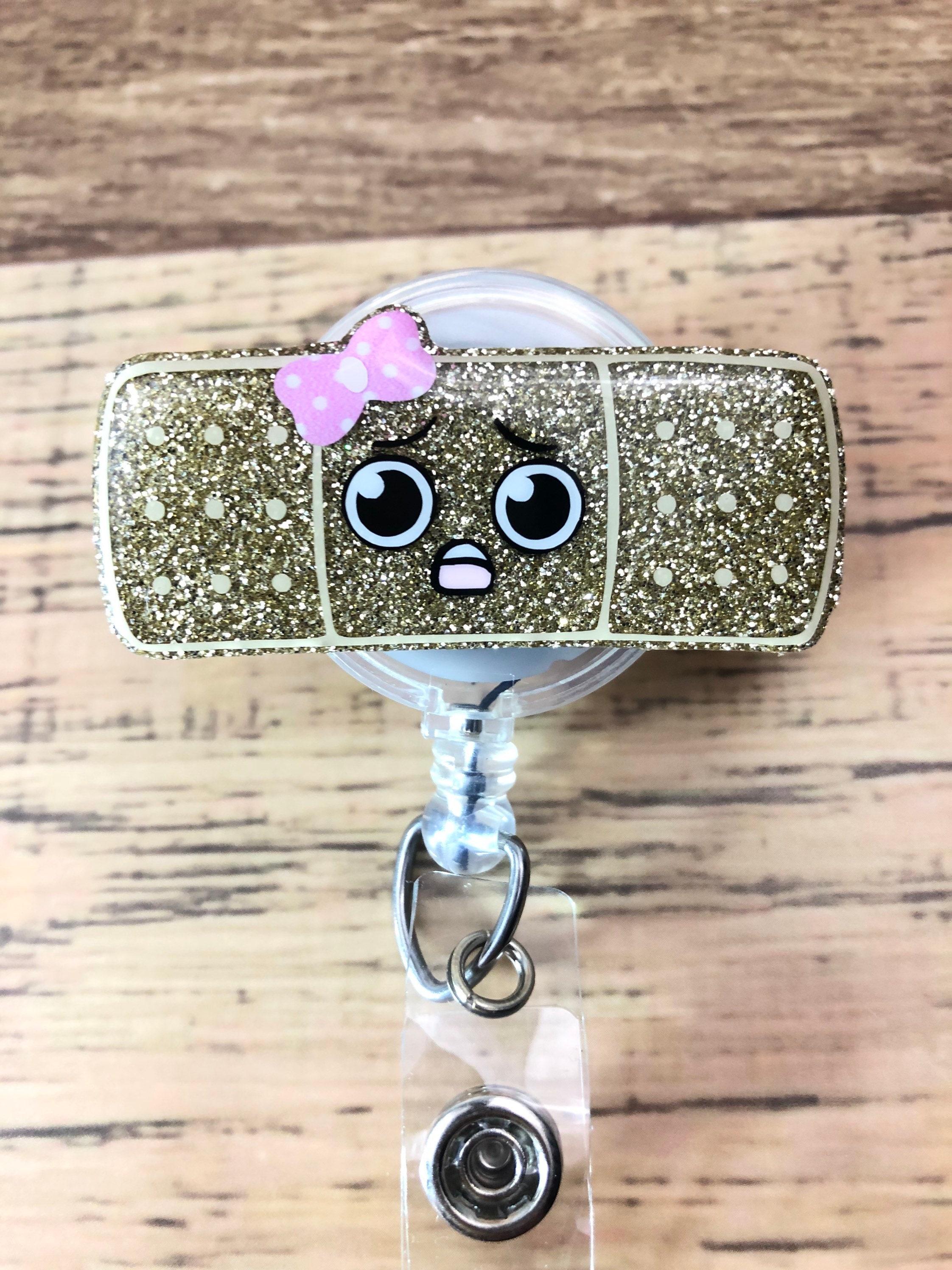 Bandaid Badge Reel • boo boo glitter kawaii cute face bow band aid nurse RN  peds pediatric healthcare medical PICU • Ready to Ship