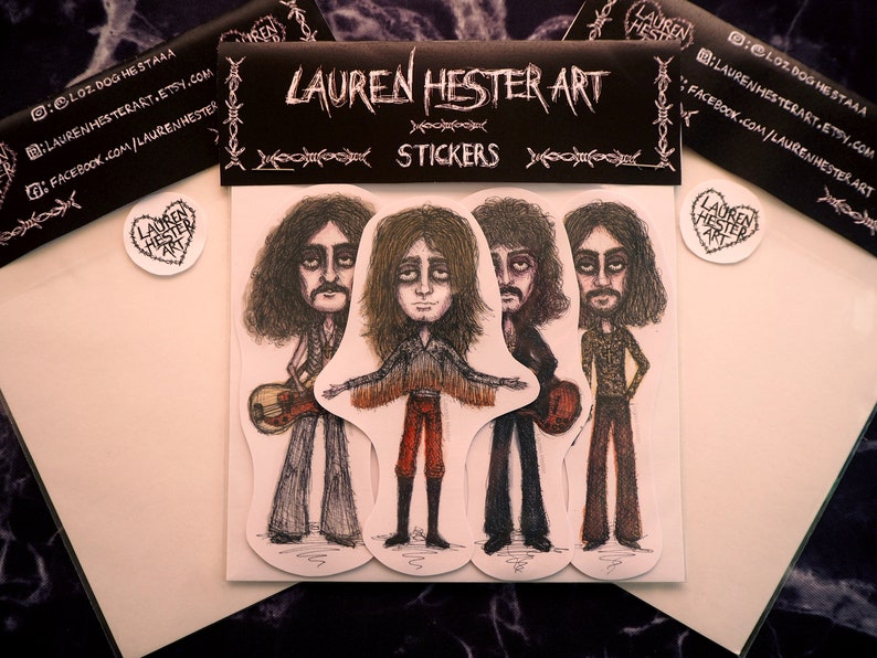 May include: Four black and white illustrated stickers of musicians with long hair. The stickers are on a white background with black text that reads "Lauren Hester Art Stickers".