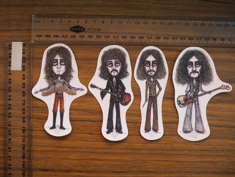 May include: Four illustrated figures of musicians with long hair, each holding a different musical instrument. The figures are drawn in black and white with some color accents. The figures are on a white background.