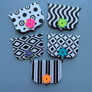May include: Five black and white patterned paper cards with a scalloped edge. Each card has a different pattern and a colorful paper flower embellishment.