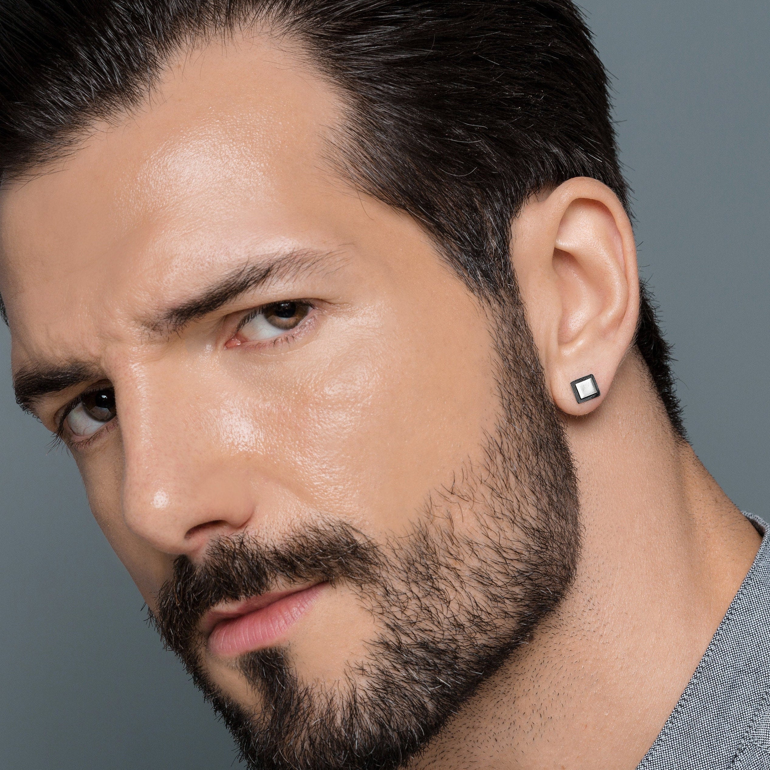 Men with ear clearance studs
