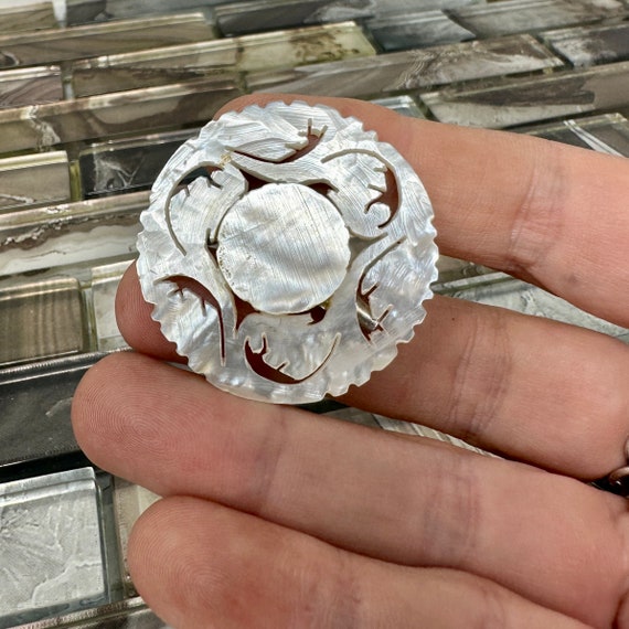 Carved brooch deals