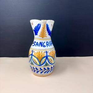 May include: A trio of ceramic mugs with a speckled, matte finish in cream, light grey, and dark grey. Each mug features a simple, minimalist design, ideal for tea or coffee.