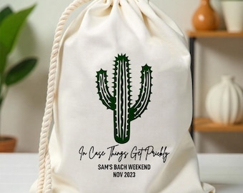May include: White canvas drawstring bag with a green cactus graphic and the text "In Case Things Get Prickly Sam's Bach Weekend Nov 2023"
