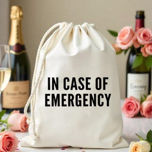 May include: A white drawstring bag with the text "IN CASE OF EMERGENCY" printed in black.