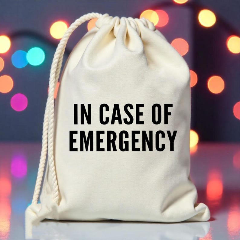 May include: A white drawstring bag with the text "IN CASE OF EMERGENCY" printed in black.