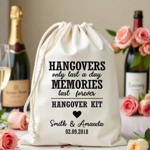 May include: White cotton drawstring bag with the text "Hangovers only last a day MEMORIES last forever HANGOVER KIT" and a heart. Below the text is "Smith & Amanda 02.09.2018".
