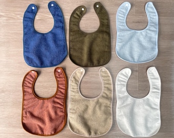 Baberos impermeables unisex con reverso de plástico para bebés. A prueba de babas.