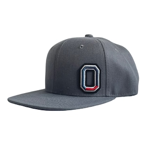 May include: A gray baseball cap with a large, embroidered, multi-colored letter "O" on the front.