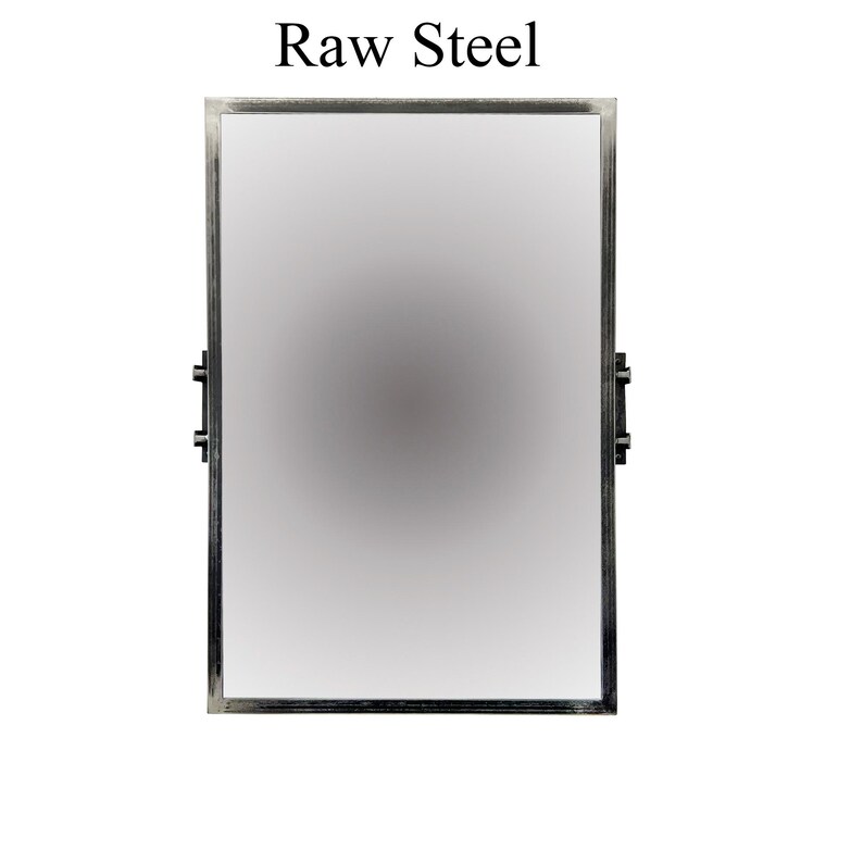 May include: A silver-colored metal picture frame with a smooth, reflective surface. The frame has a simple, rectangular design with rounded corners.