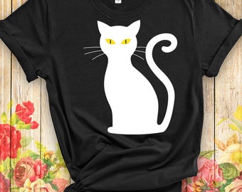 May include: Black t-shirt with a white silhouette of a cat with yellow eyes.
