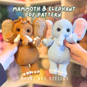May include: Two crocheted elephant plushies, one brown and one light blue, are displayed. The brown elephant has tan ears and white tusks, while the blue elephant has pink-lined ears. The text "MAMMOTH & ELEPHANT PDF PATTERN" and "HOOKS AND HEELERS" are visible.