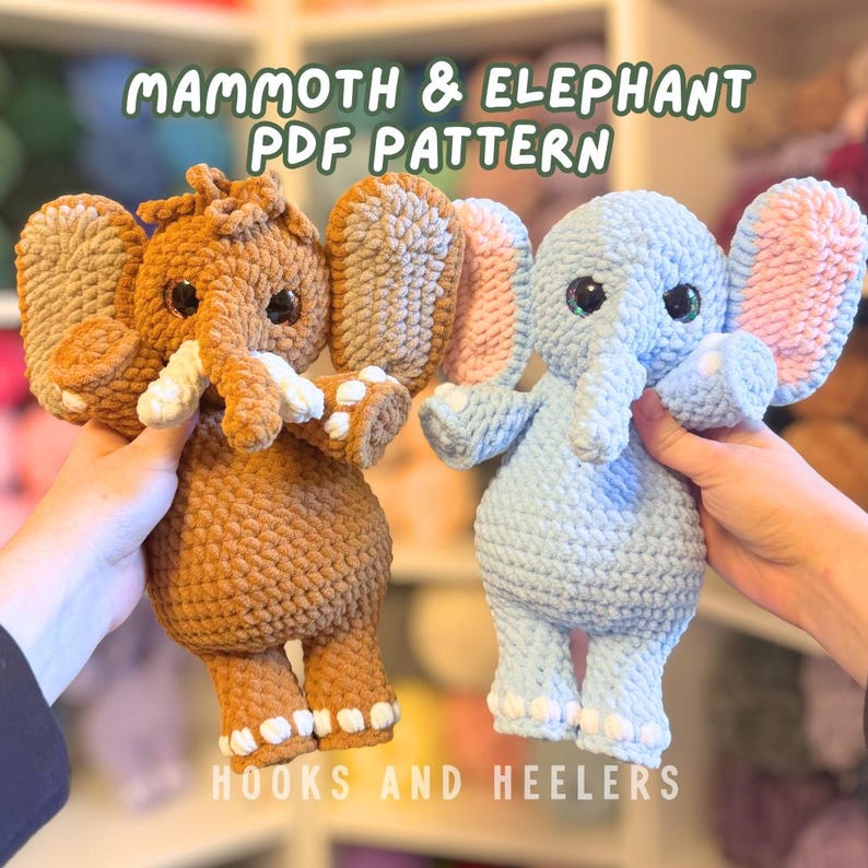 May include: Two crocheted elephant plushies, one brown and one light blue, are displayed. The brown elephant has tan ears and white tusks, while the blue elephant has pink-lined ears. The text "MAMMOTH & ELEPHANT PDF PATTERN" and "HOOKS AND HEELERS" are visible.
