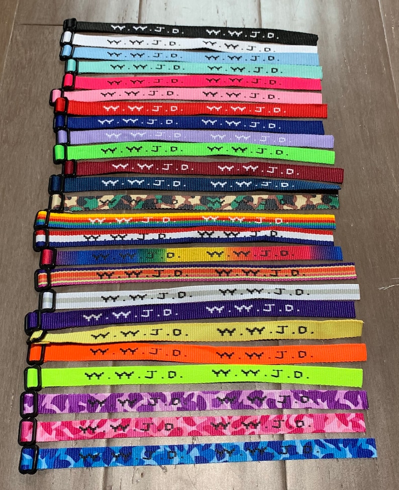 50 WWJD Qué haría Jesús Pulseras tejidas Pulseras Nuevos colores Lote a granel Joyería religiosa cristiana Vendedor de calidad genuina Bandas de oración imagen 1