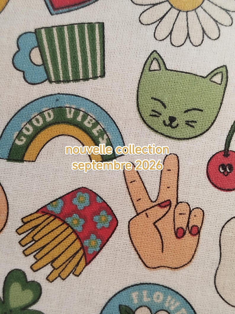 May include: A white fabric featuring a repeating pattern of colorful embroidered icons including a green cat face, a rainbow with the text GOOD VIBES, a carton of french fries, a peace sign hand, and a daisy. Text reads nouvelle collection septembre 2026.