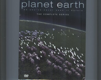 May include: A DVD box set for the BBC documentary series "Planet Earth." The cover features a herd of elephants walking across a grassy plain with a dark sky in the background. The text on the cover reads "Planet Earth as you've never seen it before" and "The Complete Series."