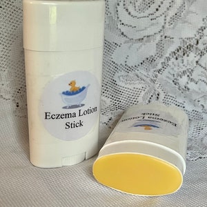 May include: Two white plastic tubes with yellow lotion inside. The tubes are labeled "Eczema Lotion Stick" with a cartoon rubber ducky in a bathtub.