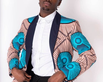 May include: A man wearing a blue and brown patterned blazer with a navy blue collar. The blazer has a geometric design with circular patterns.