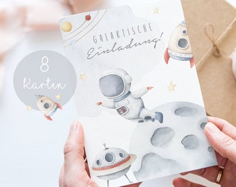 May include: A set of 8 blank invitation cards with a space theme. The cards feature a watercolor illustration of an astronaut floating in space, a rocket ship, and a planet. The text "GALAKTISCHE Einladung!" is printed on the cards.