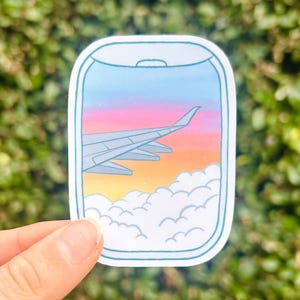 Pegatina de puesta de sol en la ventana del avión