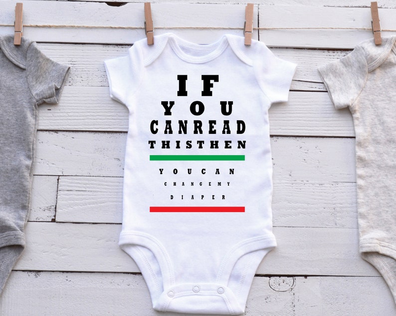 May include: White baby onesie with black text that reads "If you can read this then you can change my diaper". The text is styled like an eye chart.