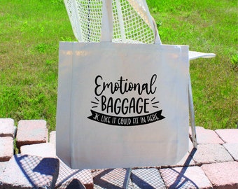 May include: White canvas tote bag with black text that reads "Emotional Baggage JK Like It Could Fit In Here".