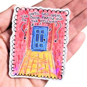 May include: A sticker with a hand-drawn illustration of a blue door at the end of a yellow brick hallway. The text reads "UNTIL GOD OPENS THE DOOR, PRAISE HIM IN THE HALLWAY."