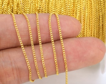 May include: A close-up of a gold chain, showing the intricate details of the links. The chain is held in a hand, highlighting its delicate nature.