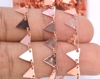 May include: Rose gold triangle chain with a delicate design. The chain is made of small, interconnected triangles that are linked together by a thin chain.