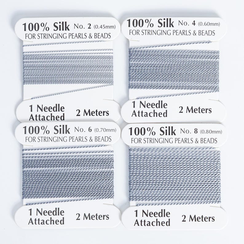 May include: Four spools of gray 100% silk thread for stringing pearls and beads. Each spool has a needle attached and contains 2 meters of thread. The thread diameters are 0.45mm, 0.60mm, 0.70mm, and 0.80mm.