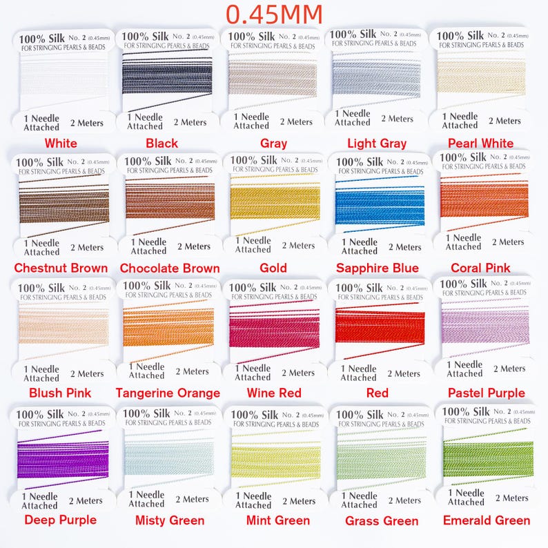 May include: A selection of silk thread spools in various colors, including white, black, gray, and red. Each spool is labeled with the thread color and specifications, such as 0.45mm thickness and 2 meters of thread.