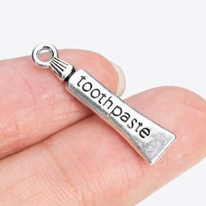 10 Zahnpasta Anhänger doppelseitig Antik Silber Ton (66675-3390)