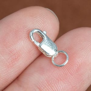 May include: Silver-toned lobster clasp with a jump ring. The clasp is a common jewelry finding used for necklaces, bracelets, and other jewelry.