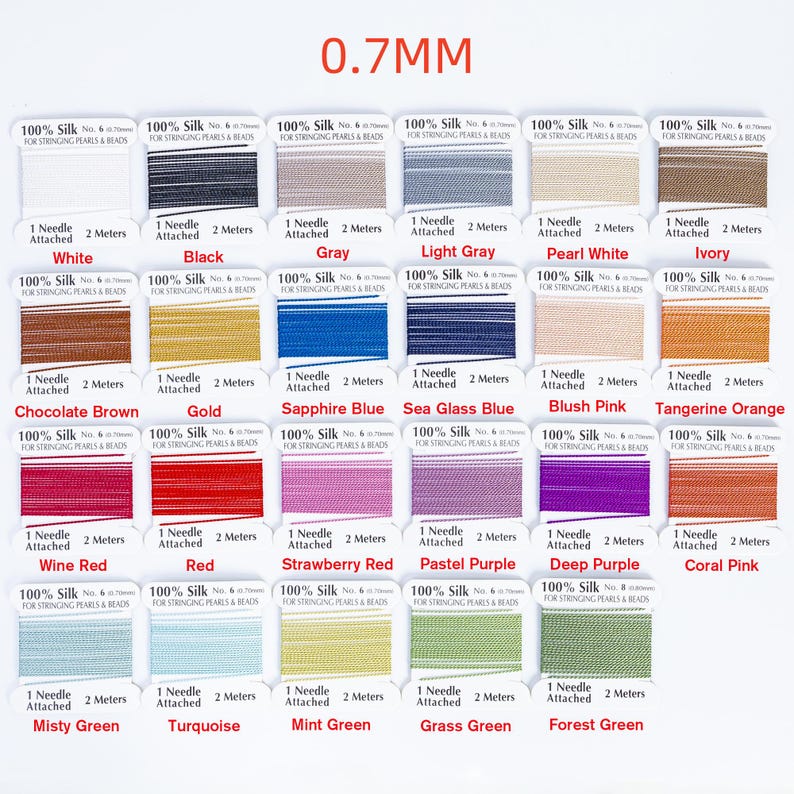 May include: A collection of silk thread spools in various colors, including white, black, gray, and shades of blue, pink, and green. Each spool is labeled with its color and includes a needle and 2 meters of thread. The text "0.7MM" is at the top.