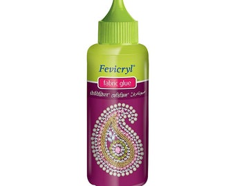 May include: A bottle of Fevicryl fabric glue with a green cap and a pink and gold paisley design on the label. The label also includes the text "Fevicryl fabric glue" in English, Hindi, and Arabic.