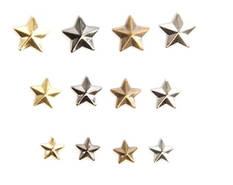 May include: Twelve metal star-shaped embellishments in three different finishes: gold, silver, and bronze. The stars are arranged in three rows of four.