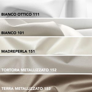 May include: Close-up of five fabric swatches in varying shades of white, beige, and brown. The top swatch is labeled "BIANCO OTTICO 111", followed by "BIANCO 101", "MADREPERLA 151", "TORTORA METALLIZZATO 152", and "TERRA METALLIZZATO 153". The fabrics have a textured appearance.