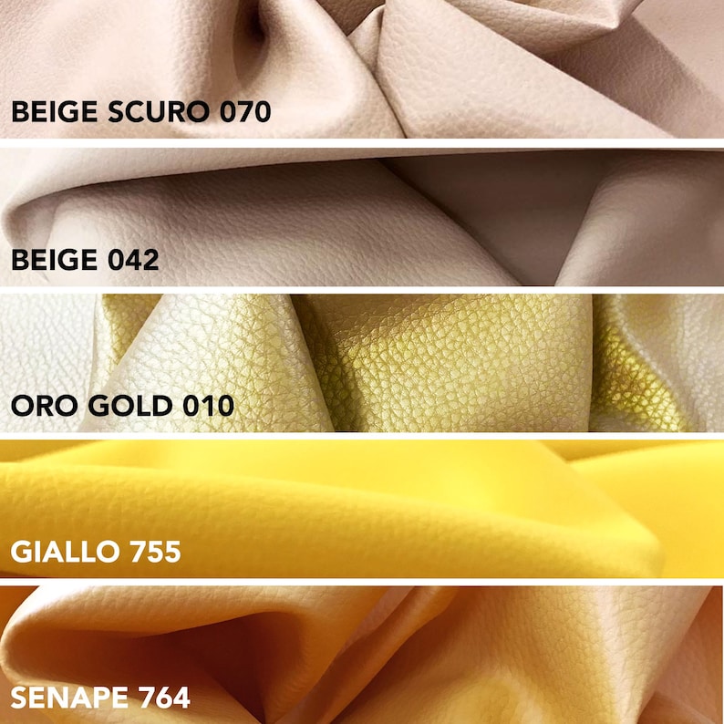 May include: Close-up of fabric swatches in various colors. The swatches include beige, gold, and yellow tones. Each swatch has a label with a color name and number. The fabric appears to have a textured surface.