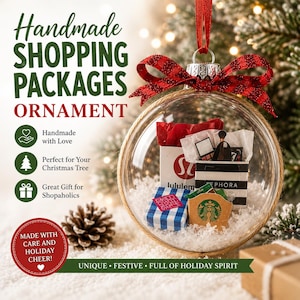 May include: Clear glass ornament filled with miniature shopping bags from Lululemon, Sephora, Bath & Body Works, and Starbucks. The ornament has a red ribbon and is decorated with a jute rope. Text on the ornament reads "Handmade Shopping Packages Ornament."