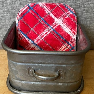 May include: A galvanized metal storage bin with a handle and a red and white plaid fabric liner.