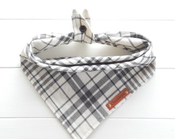 May include: A white and black plaid bandana with a brown leather tag that says "Chumleys".