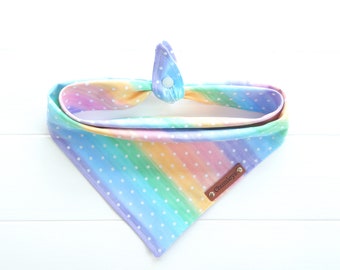 May include: A rainbow-colored dog bandana with white polka dots and a brown leather tag that says "Chumleys".