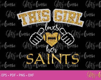 May include: Gold glitter graphic design with the text "This Girl Loves Her Saints" and a football in a heart shape.