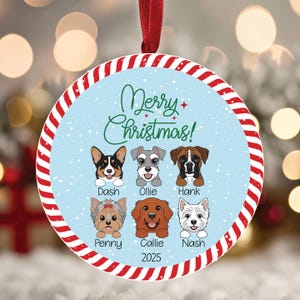 May include: Round Christmas ornament with a red and white striped border and a red ribbon. The ornament features six dog illustrations and the text "Merry Christmas!". The dogs are named Dash, Ollie, Hank, Penny, Callie, and Nash. The year 2025 is also included.