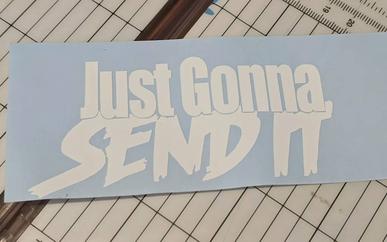 May include: White vinyl sticker with the text "Just Gonna Send It" in a bold, stylized font.