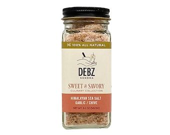 May include: A clear glass spice jar with a black screw-top lid containing pink Himalayan sea salt with garlic and chive. The label features the text DEBZ SONOMA, SWEET & SAVORY CULINARY COLLECTION, and HIMALAYAN SEA SALT GARLIC / CHIVE, NET WT. 141.75G.