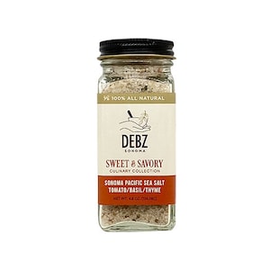 May include: A glass jar of Sonoma Pacific Sea Salt with tomato, basil, and thyme. The jar is labeled "Debz Sonoma Sweet & Savory Culinary Collection" and has a net weight of 4.8 ounces (136.08g).