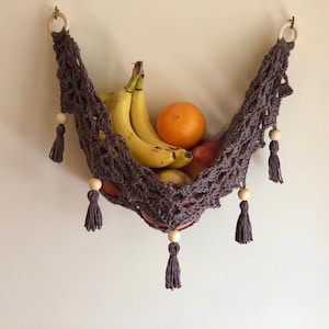 Crochet hammock pattern works as a crochet wall hanging, crochet fruit holder, or crochet home decor organizer. The lacy crochet stitch design makes this pattern both fashionable and functional.