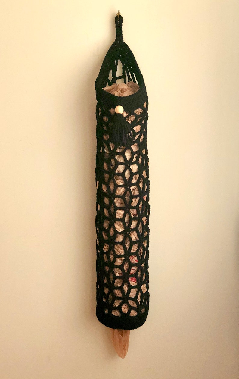 Crochet grocery bag holder pattern in beautiful boho crochet design. This functional boho bag saver will look great as crochet wall decor and function as a crochet organizer.