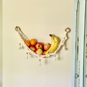 Crochet hammock pattern works as a crochet wall hanging, crochet fruit holder, or crochet home decor organizer. The lacy crochet stitch design makes this pattern both fashionable and functional.